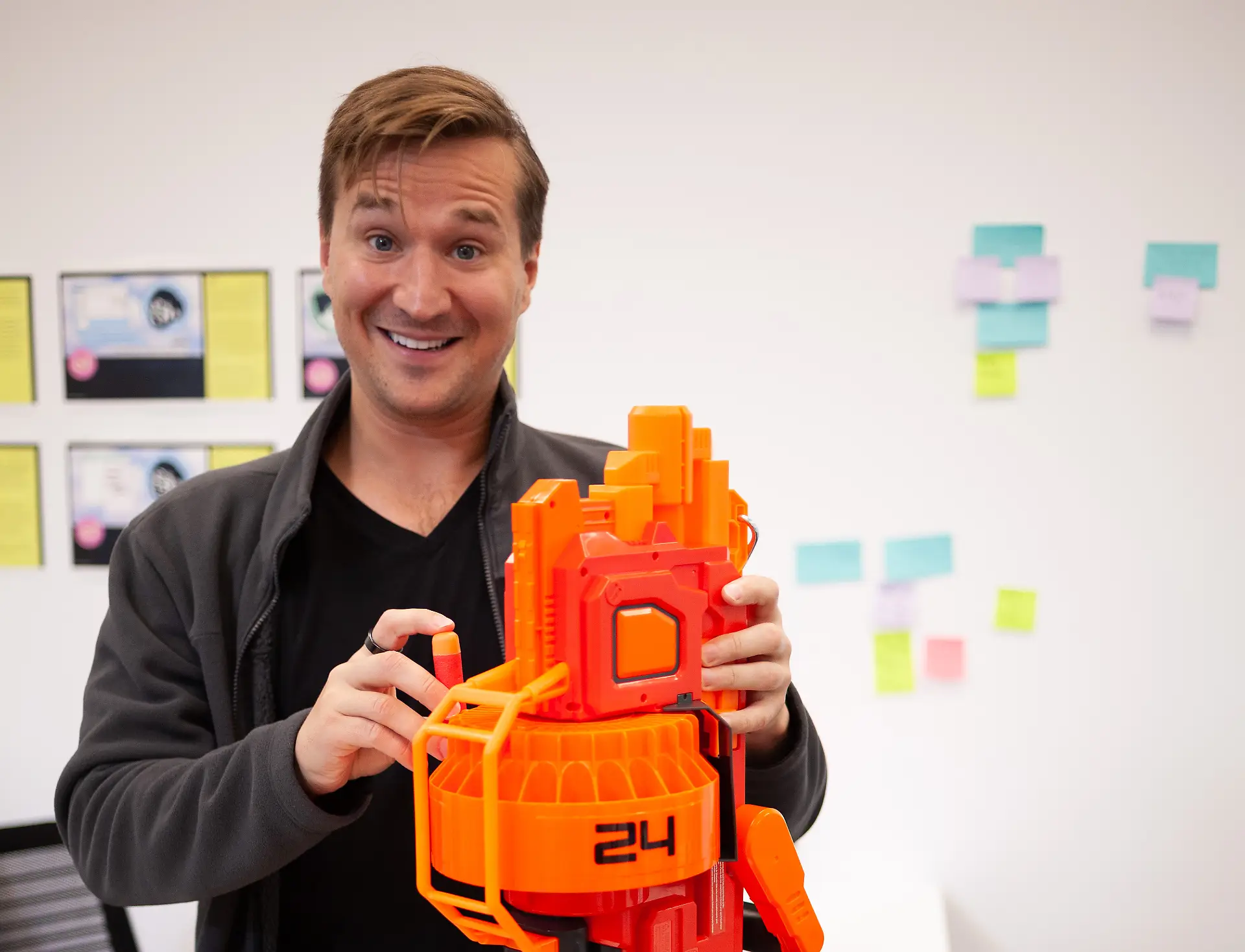 Nate Tower loading up a Nerf gun in an IDEO project space